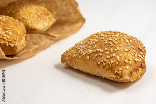 Israeli puff pastry Bourekas with cheese on white background.