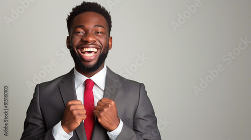 a smiling happy business African American man with fists clenched