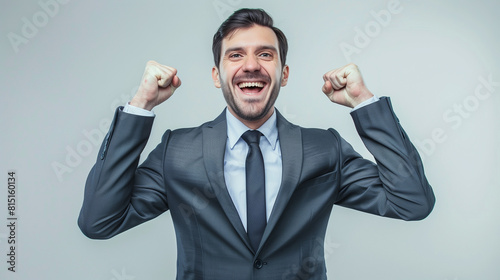 a smiling happy business man with fists clenched success