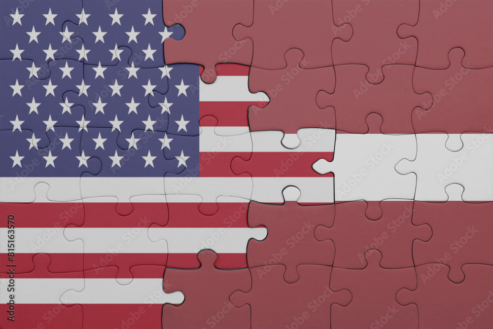puzzle with the colourful national flag of latvia and flag of united ...