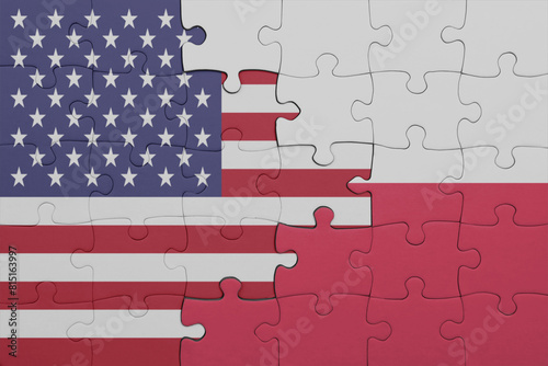 puzzle with the colourful national flag of poland and flag of united states of america .