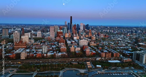 Twilight view of immense New York from top. The little discus of the Moon in the blue sky over the scenery. photo
