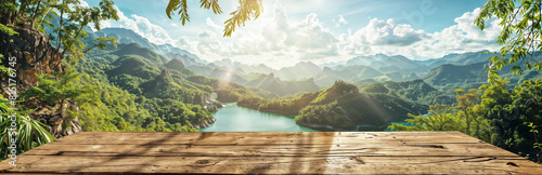 Scenic view from a wooden board on a hill to a beautiful lake in a tropical jungle landscape