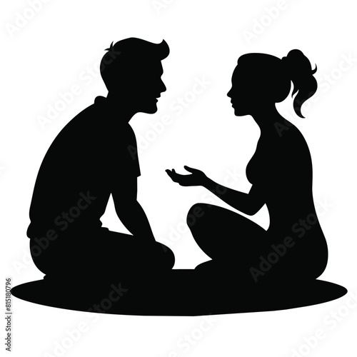 A girlfriend and boyfriend talking to each other while sitting on the ground