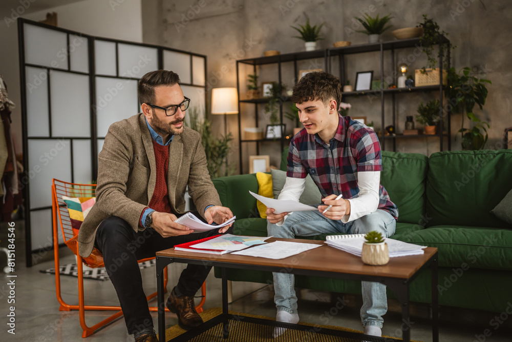 Adult professor mentor have a class with young student at home Adult professor mentor have a class with young student at home