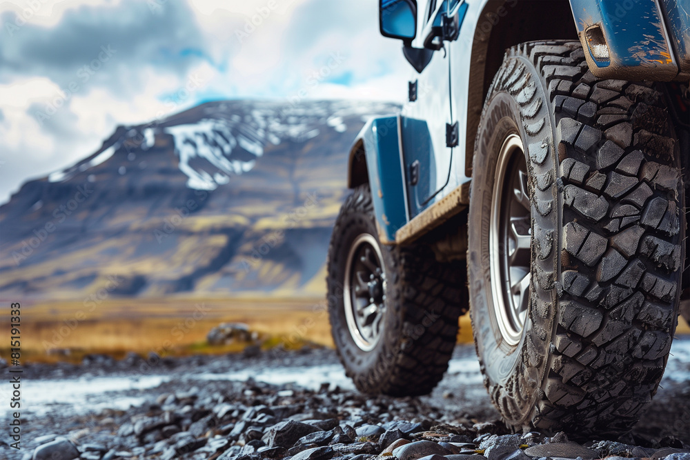 SUV wheel on the off-road adventure trail against the backdrop of mountains in the clouds SUV wheel on the off-road adventure trail against the backdrop of mountains in the clouds