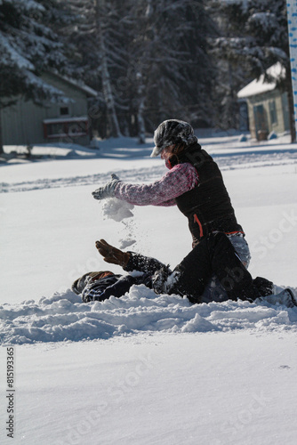 Man braves freezing snow to carry another in winter sports gear for a fun event