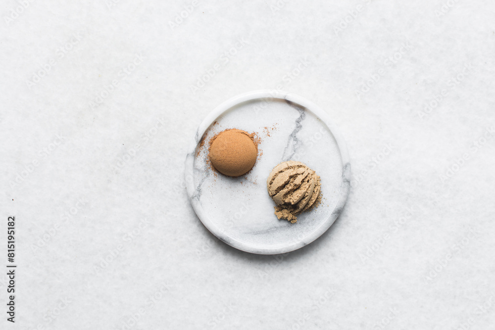 Teaspoon of cinnamon and allspice on a white tray, Saigon cinnamon, cinnamon powder on a marble tray