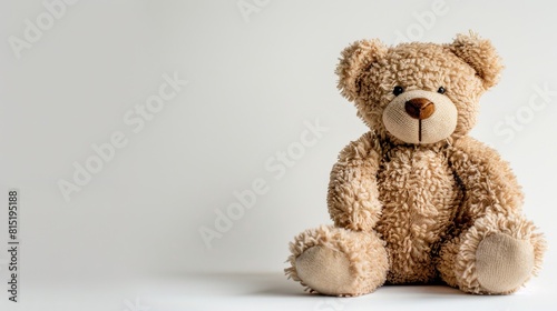 An adorable teddy bear stands out against a crisp white background