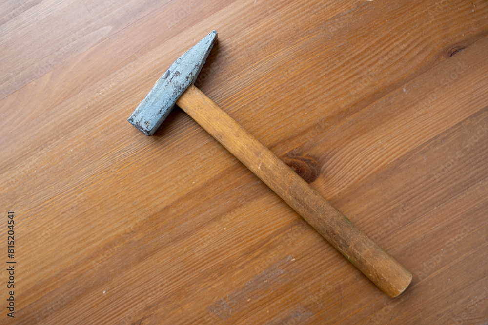 Hammer Laying on Wooden Floor
