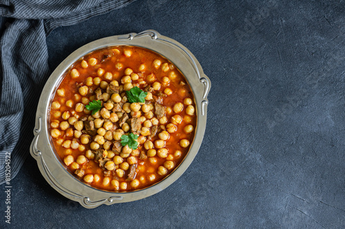 Delicious traditional turkish chickpea dish with meat in metal plate, turkish meal