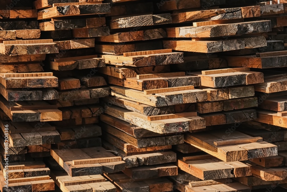 Wooden planks heap as background. Air-drying timber stack. Pile of wooden boards in sawmill, planking, sawing boards. Wooden planks heap as background. Air-drying timber stack. Pile of wooden boards in sawmill, planking, sawing boards.
