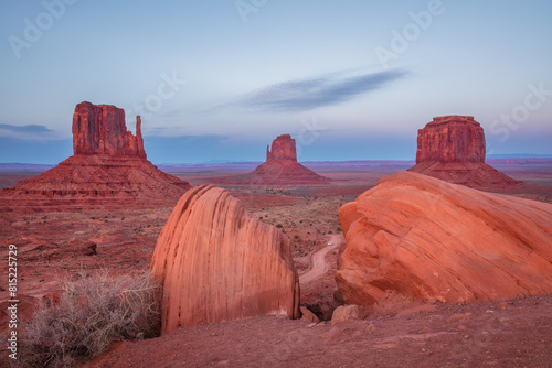 Monument Valley scenic view in Arizona at shortly after the sunset with red rock formations in the foreground photo