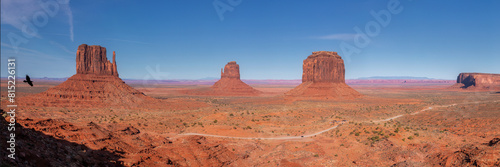 Scenic panoramic view of the epic Monument Valley in USA with a black bird flying in the foreground photo