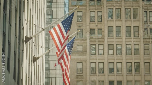 American flags on Wall Street in New York. USA flags waving in the heart of worldwide stock trade district. National flags on American buildings. 