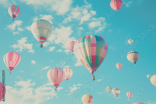 Colorful hot air balloons floating in a clear blue sky  a dreamy scene for leisure and adventure themes.  
