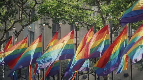 Slowmotion shot of pride flags moving in wind in the middle of the New York City. Pride flags in Manhattan and Brooklyn. 