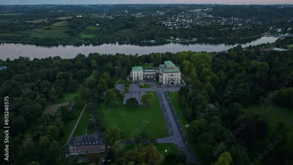 Aerial drone view of Villa Hügel in Essen, Germany. The Villa Hügel is a 19th-century mansion located in the Bredeney district, now part of Essen. A beautiful castle on the mountainside . Aerial drone view of Villa Hügel in Essen, Germany. The Villa Hügel is a 19th-century mansion located in the Bredeney district, now part of Essen. A beautiful castle on the mountainside .