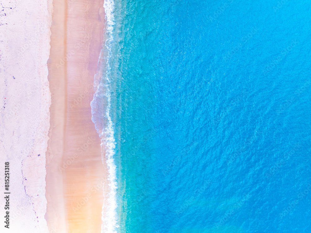 Fototapeta premium Amazing Top view sea beach landscape background,Summer sea waves crashing on sandy shore seascape background,High angle view ocean nature background