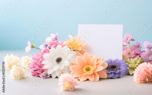 A bouquet of flowers with a white card on top