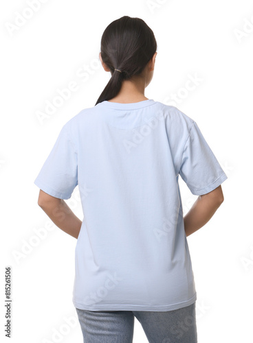 Woman wearing light blue t-shirt on white background, back view