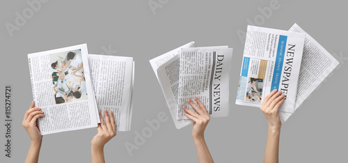 Women with newspapers on grey background photo