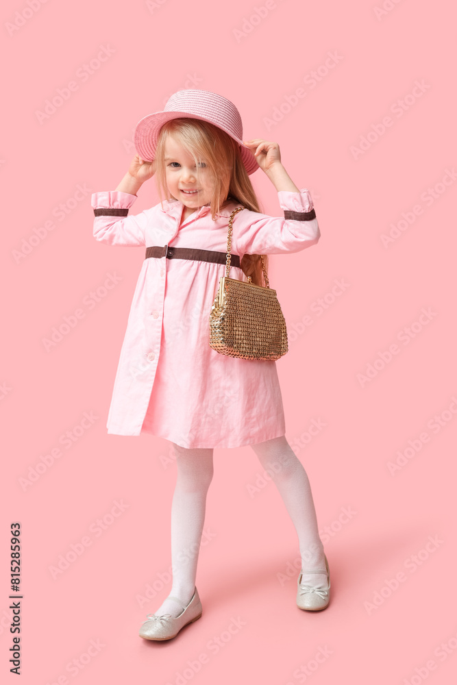 Cute little girl with stylish golden purse on pink background Cute little girl with stylish golden purse on pink background