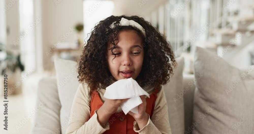 Sick, little girl and blowing nose with tissue on sofa for fever, flu or symptoms in living room at home. Young female person, child or kid with cold, illness or allegies on lounge couch at house