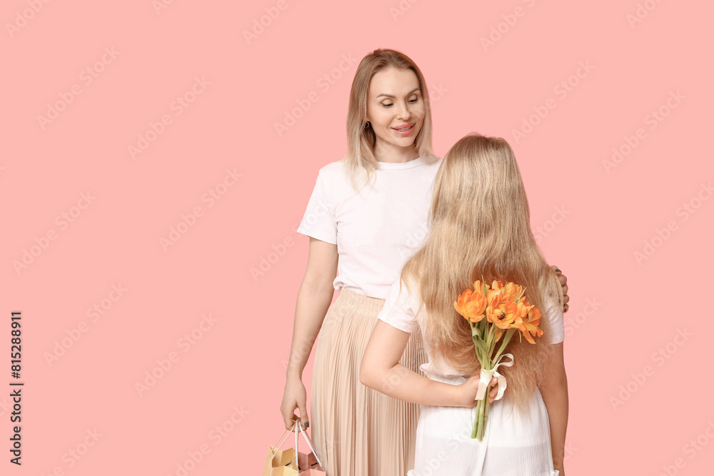Cute little girl hiding bouquet for mom behind her back on pink background. Mother's Day concept Cute little girl hiding bouquet for mom behind her back on pink background. Mother's Day concept