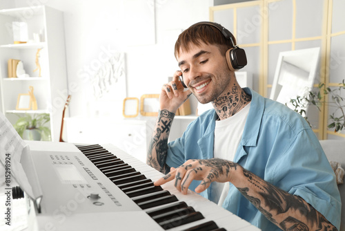 Smiling young man with tatt...