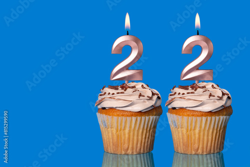 Birthday Cupcakes With Candles Lit Forming The Number 22.