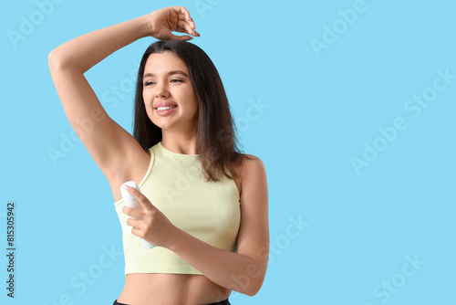 Sporty young woman spraying...