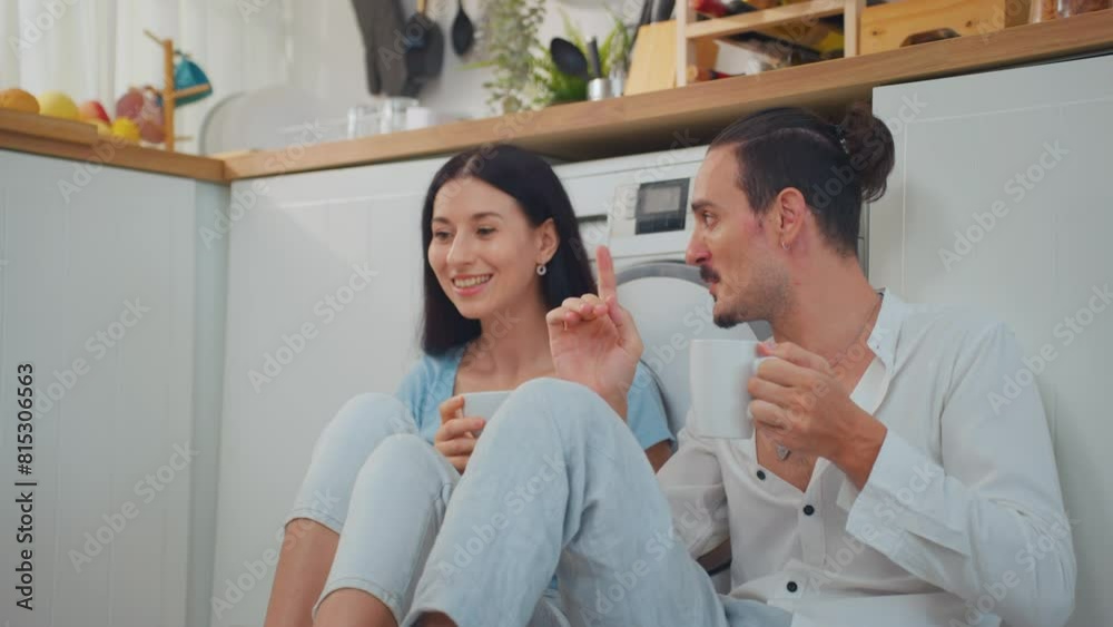 Caucasian young couple spend free leisure time together in kitchen room. Caucasian young couple spend free leisure time together in kitchen room.