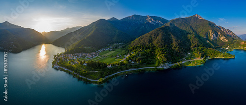 Aerial Panoramic View of Lake Ledro Surrounded by Lush Greenery and Mountains