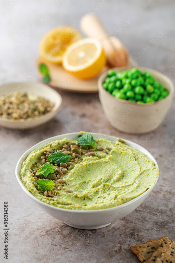 Hummus made of chickpeas, fresh green peas and mint, sprinkled with seeds Hummus made of chickpeas, fresh green peas and mint, sprinkled with seeds