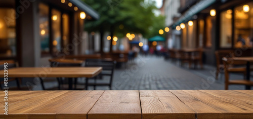 Empty wooden table in front of blurred cafe or restaurant  Food poster or menu display concept