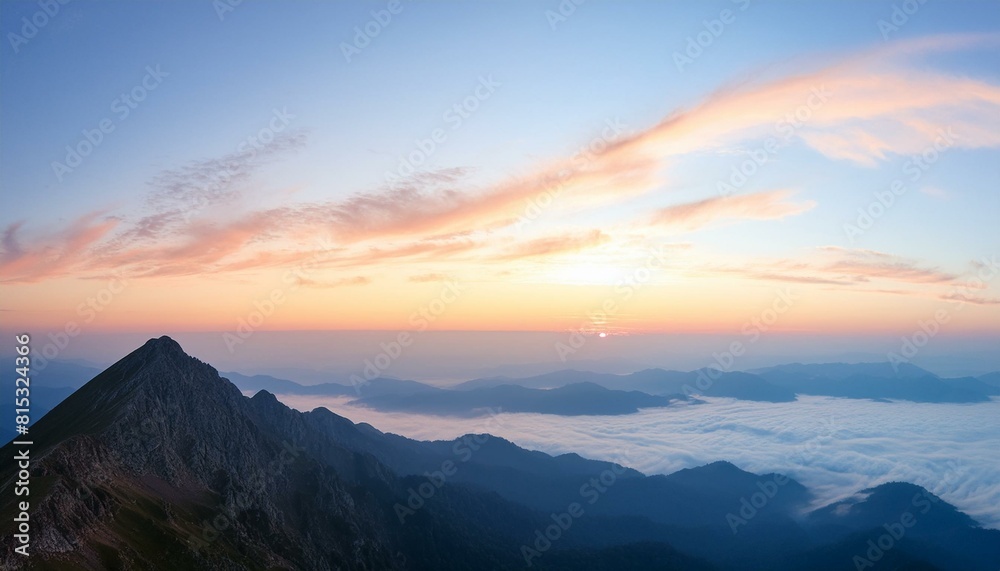 sunrise over the mountains. A majestic view from the top of a high mountain at sunrise. The sky is a gradient of light sunrise over the mountains. A majestic view from the top of a high mountain at sunrise. The sky is a gradient of light