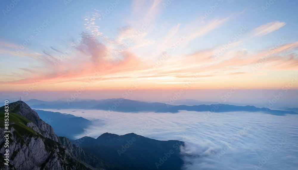 sunrise over the mountains. A majestic view from the top of a high mountain at sunrise. The sky is a gradient of light sunrise over the mountains. A majestic view from the top of a high mountain at sunrise. The sky is a gradient of light