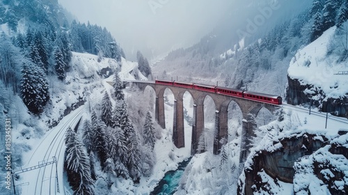 Aerial View of the Landwasser Viaduct with Railway without famous train at winter, landmark of Switzerland, snowing, river and mountains --ar 16:9 Job ID: 4738de80-e848-42ce-bd33-5dac2b714498 photo