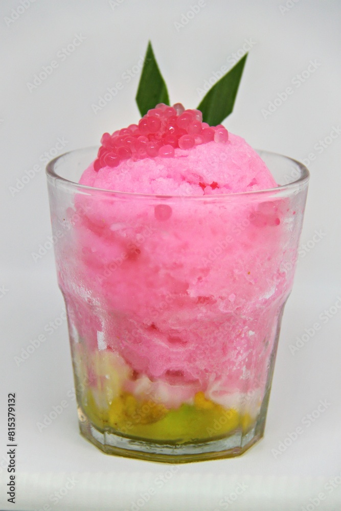 Es doger made from sugared sweet coconut milk based ice in pink syrup, served with red tapioca pearls, avocado, cassava tapai, black glutinous rice, jackfruit, diced bread and condensed milk. Es doger made from sugared sweet coconut milk based ice in pink syrup, served with red tapioca pearls, avocado, cassava tapai, black glutinous rice, jackfruit, diced bread and condensed milk.