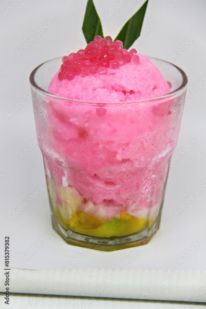 Es doger made from sugared sweet coconut milk based ice in pink syrup, served with red tapioca pearls, avocado, cassava tapai, black glutinous rice, jackfruit, diced bread and condensed milk. Es doger made from sugared sweet coconut milk based ice in pink syrup, served with red tapioca pearls, avocado, cassava tapai, black glutinous rice, jackfruit, diced bread and condensed milk.