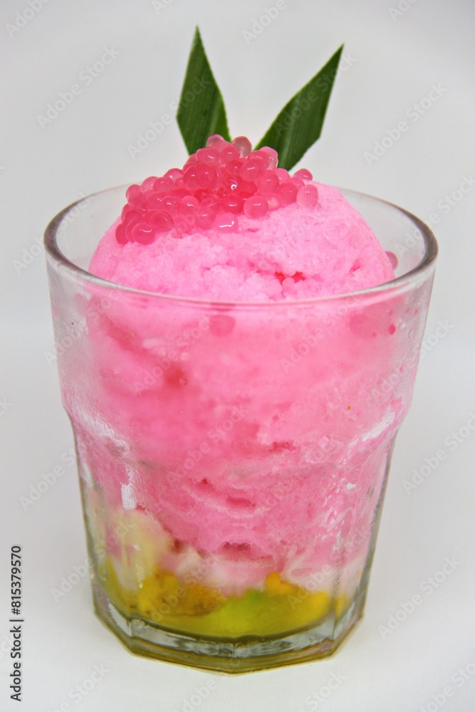 Es doger made from sugared sweet coconut milk based ice in pink syrup, served with red tapioca pearls, avocado, cassava tapai, black glutinous rice, jackfruit, diced bread and condensed milk. Es doger made from sugared sweet coconut milk based ice in pink syrup, served with red tapioca pearls, avocado, cassava tapai, black glutinous rice, jackfruit, diced bread and condensed milk.