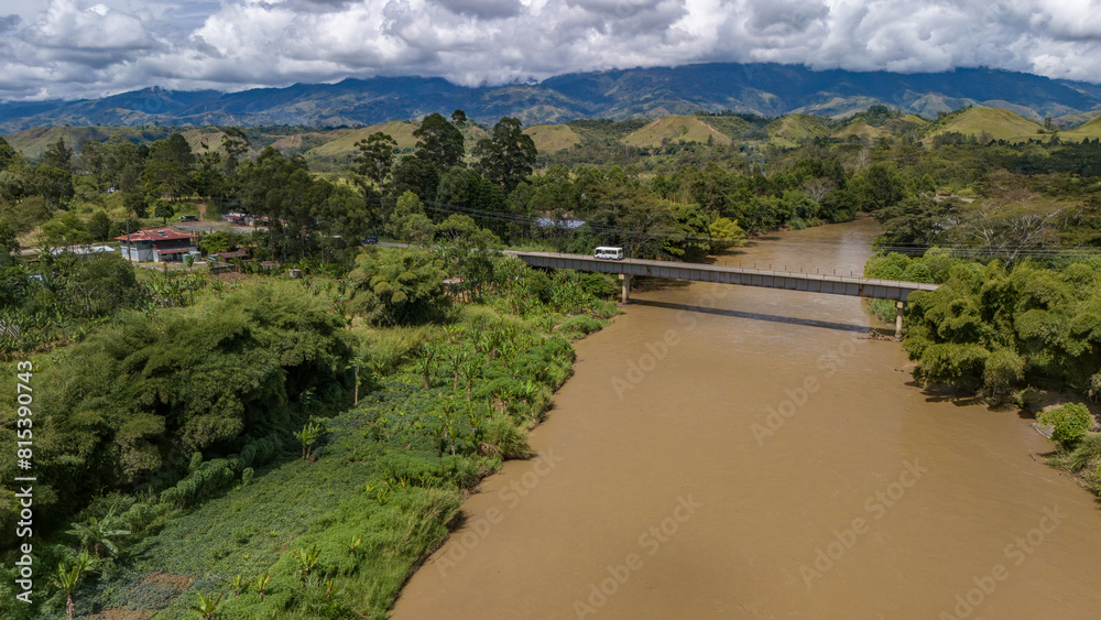 A flooding river reaches its high banks in the highlands of PNG.