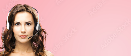 Call center help line service ad concept - face portrait customer support sales operator in headset, isolated rose pink background. Brunette beautiful woman. Caller worker. Phone advisor. Banner image