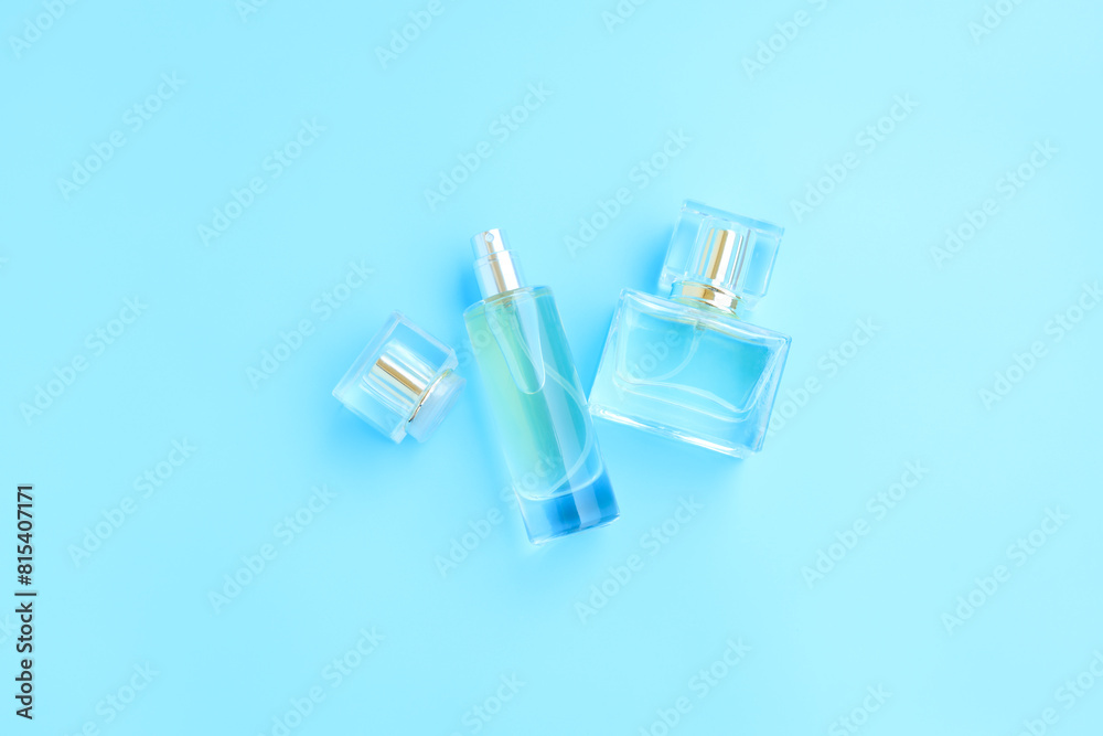 Perfume bottle on blue background, Glass bottle of perfumery Perfume bottle on blue background, Glass bottle of perfumery