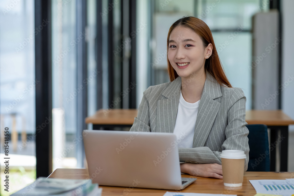 Asian business woman working In office using laptop and tablet, business concept Asian business woman working In office using laptop and tablet, business concept