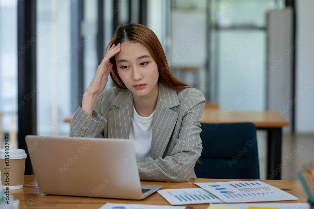 Asian businesswoman is tired and stressed in the office. Business concept. Asian businesswoman is tired and stressed in the office. Business concept.