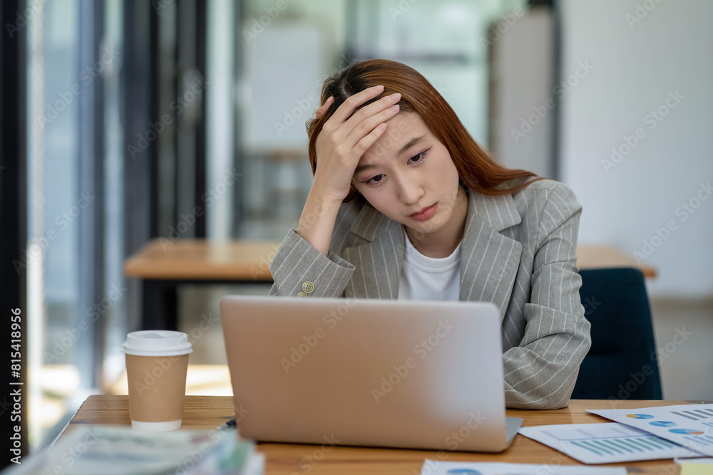 Asian businesswoman is tired and stressed in the office. Business concept. Asian businesswoman is tired and stressed in the office. Business concept.