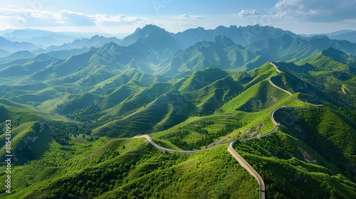 Aerial view of the Great Wall of China stretching across rugged mountains and valleys, with sections winding over steep ridges and through lush forests. 