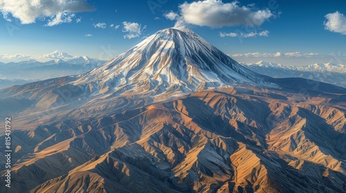 Aerial view of the Mount Damavand in Iran, featuring the majestic volcanic peak with its snow-covered summit and the surrounding rugged terrain.      photo